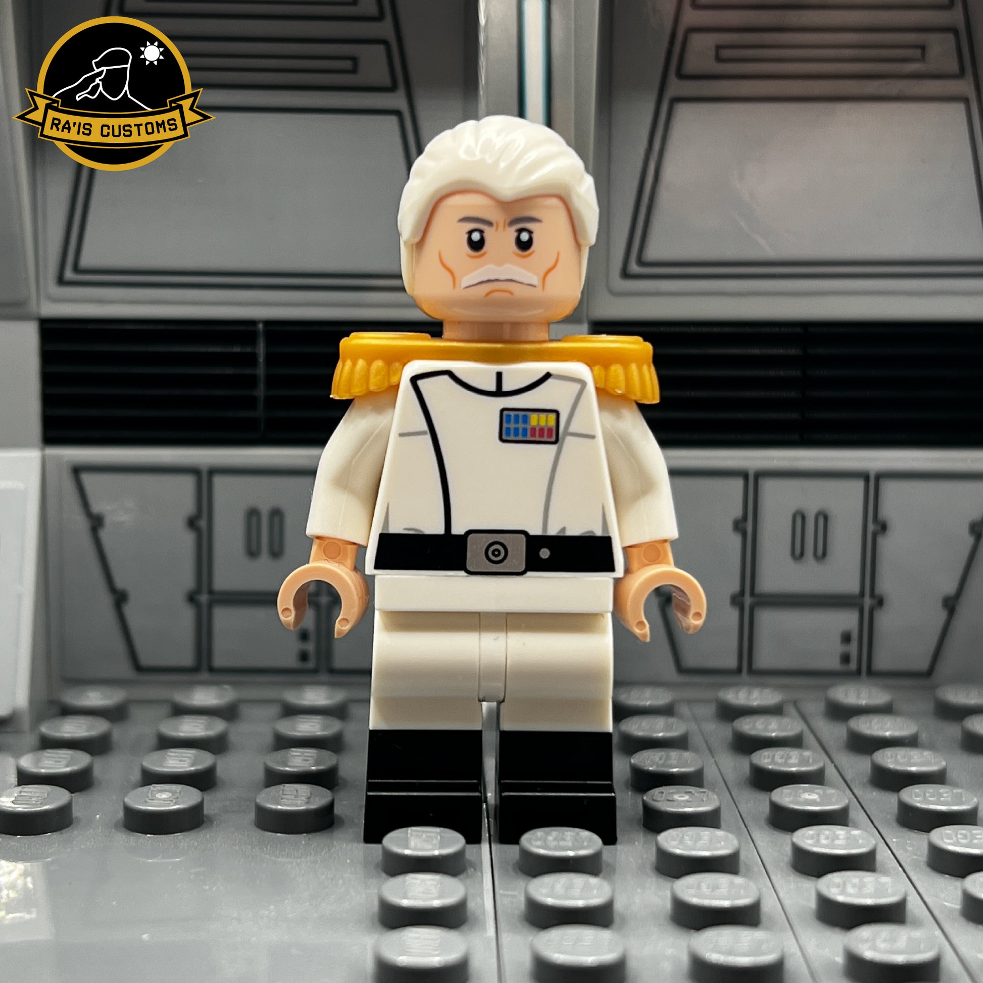 Custom LEGO minifigure of Grand Admiral Pellaeon from Star Wars, created by Ra'is Customs. Features an accurate white uniform with gold epaulets, rank insignia, and a detailed facial design. Displayed in a Star Wars-themed diorama with a futuristic gray backdrop, this figure is ideal for collectors and fans seeking high-quality custom LEGO minifigures.